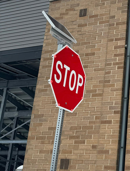 Blinking stop sign installed on a standard pole